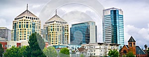 Modern buildings in downtown Oakland rising behind old ones; cloudy spring day; San Francisco bay area, California