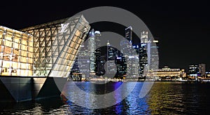 Modern buildings and lights on sea and abstract architectures and night skyline in Singapore