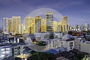 Modern buildings of the Makati district,illuminated by artificial lighting,at dusk,Metro Manila,The Philippines