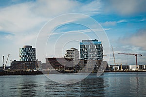 Modern buildings under construction by the water