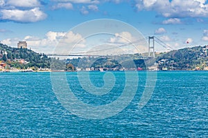 Modern builings and Rumelian Castle, and Fatih Sultan Mehmet Bridge across the Bosphorus strait in Istanbul Turkey from ferry on a