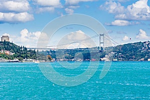 Modern builings and Rumelian Castle, and Fatih Sultan Mehmet Bridge across the Bosphorus strait in Istanbul Turkey from ferry on a