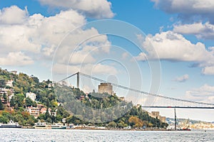 Modern builings and Rumelian Castle, and Fatih Sultan Mehmet Bridge across the Bosphorus strait in Istanbul Turkey from ferry on a