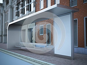 Modern bus stop with blank billboard near brick wall.