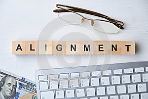 Modern business buzzword - alignment. Top view on wooden table with blocks. Top view