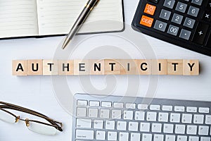 Modern business buzzword - authenticity. Top view on wooden table with blocks. Top view