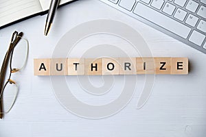 Modern business buzzword - authorize. Top view on wooden table with blocks. Top view