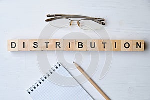 Modern business buzzword - distribution. Top view on wooden table with blocks. Top view