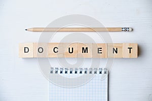 Modern business buzzword - document. Top view on wooden table with blocks. Top view