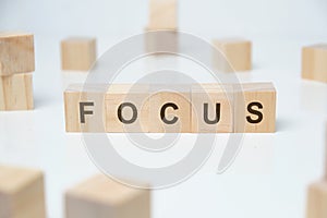 Modern business buzzword - focus. Word on wooden blocks on a white background