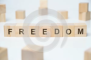 Modern business buzzword - freedom. Word on wooden blocks on a white background