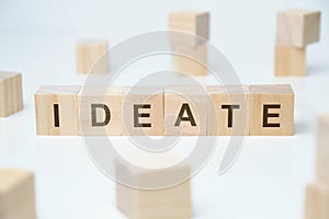 Modern business buzzword - ideate. Word on wooden blocks on a white background photo