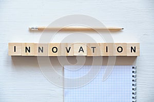 Modern business buzzword - innovation. Top view on wooden table with blocks. Top view