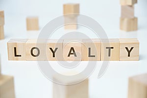 Modern business buzzword - loyalty. Word on wooden blocks on a white background