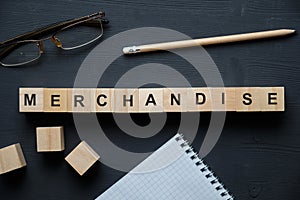 Modern business buzzword - merchandise. Top view on wooden table with blocks. Top view