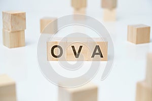 Modern business buzzword - OVA. Word on wooden blocks on a white background photo
