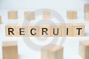 Modern business buzzword - recruit. Word on wooden blocks on a white background