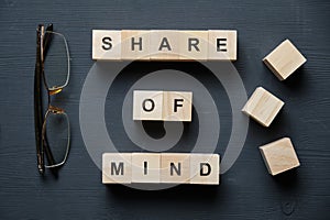 Modern business buzzword - share of mind. Top view on wooden table with blocks. Top view