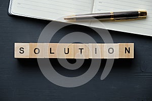 Modern business buzzword - solution. Top view on wooden table with blocks. Top view