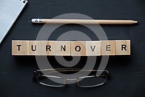 Modern business buzzword - turnover. Top view on wooden table with blocks. Top view