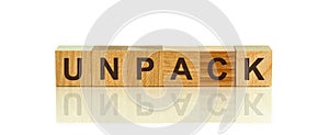 Modern business buzzword - UNPACK. Word on wooden blocks on a white background. Close up