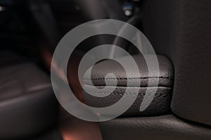 Modern business car interior detail. Leather background. Auto door armrest. photo