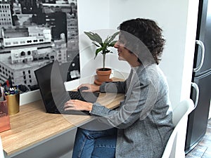 Modern business caucasian woman smiling while working on her laptop