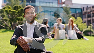 Modern business centre at the lunch time office manger black man posing in front of the camera very charismatic smiling