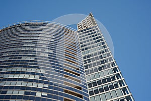 Modern business glass building on blue sky background