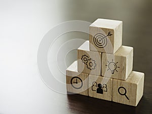 Modern business icons on wooden cube blocks.