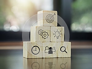 Modern business icons on wooden cube blocks.