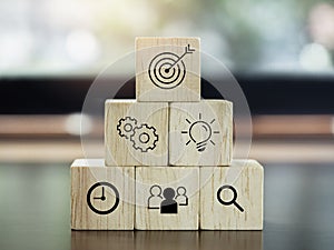 Modern business icons on wooden cube blocks.