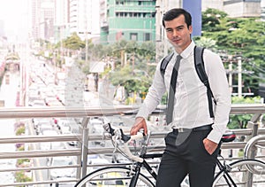 Modern Business man cycling bicycle to work to avoid traffic
