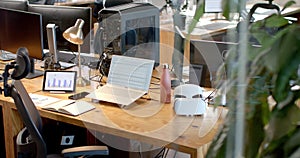 A modern business office desk setup with multiple screens and gadgets