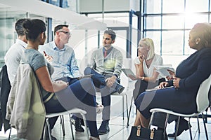 Modern business people in an informal team building discussion or business talking session. Team leader, manager or