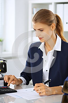 Modern business woman or confident female accountant in office. Student girl during exam preparing. Audit, tax service