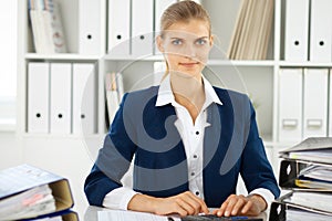 Modern business woman or confident female accountant in office. Student girl during exam preparing. Audit, tax service