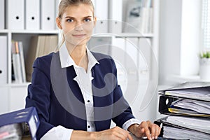 Modern business woman or confident female accountant in office. Student girl during exam preparing. Audit, tax service