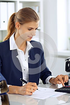 Modern business woman or confident female accountant in office. Student girl during exam preparing. Audit, tax service