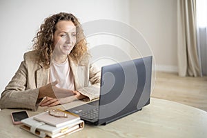 Modern business woman working online use laptop making notes e learning distance education at home