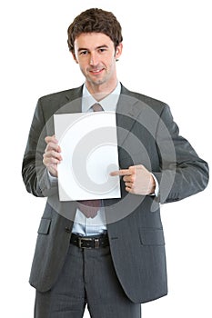 Modern businessman pointing on blank paper sheet