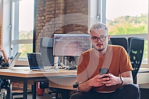 A modern businessman takes a relaxing break from work, using his smartphone to unwind and recharge during his pause