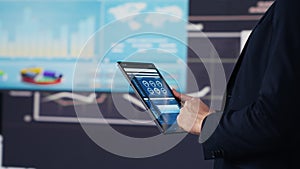 Modern businessman uses digital graphs and analytics to improve finance models