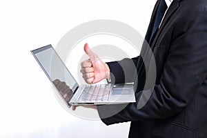 Modern businessman wearing a black suit. Holding hand thumbs up