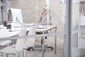 Modern Businesswoman Speaking by Phone in Office