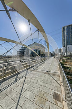 Modern butterfly bridge against blue sky and bright sun in Austin Texas