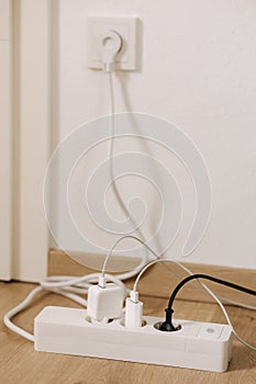 Modern cable connector for overloaded power boards at home. The extension cord is filled with sockets