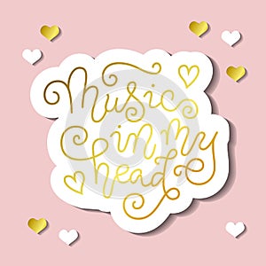 Modern calligraphy lettering of Music in my head in golden with white outline on pink background