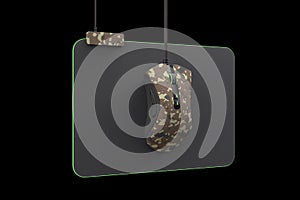 Modern camouflage gaming mouse on professional pad on black with clipping path