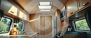 Modern camper van kitchen interior with sunlight streaming through windows. Bright and airy space with wood cabinets and